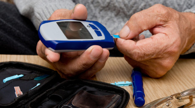 man using glucometer