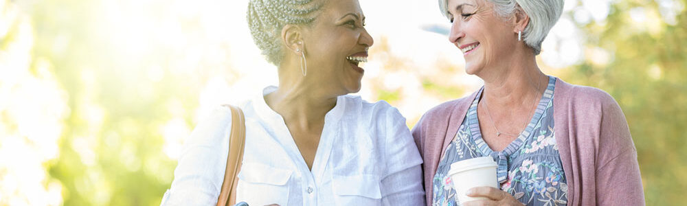 Smiling senior ladies with strong bones walk and chat