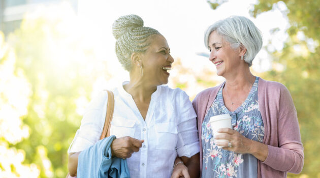 Smiling senior ladies with strong bones walk and chat