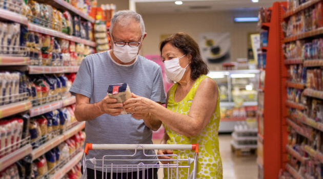 Two people looking at something in a store.