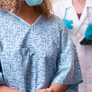 Doctor standing behind a patient.