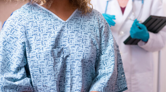 Doctor standing behind a patient.