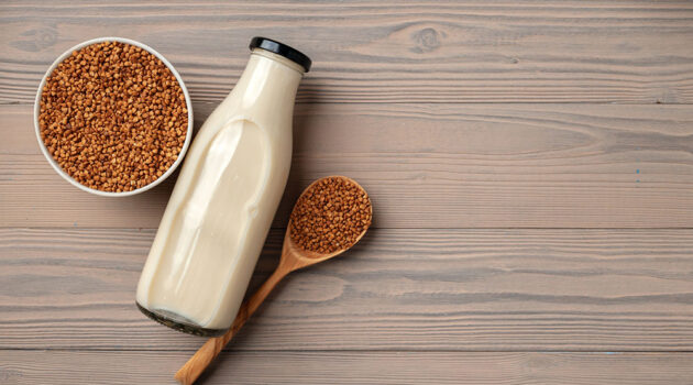 Container of buckwheat in cup on table top.