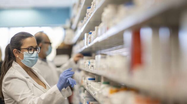 Pharmacist looking at a shelf.