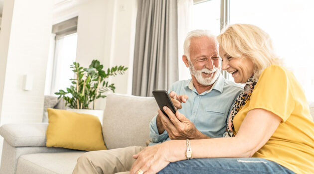 Older couple sitting next to each other.