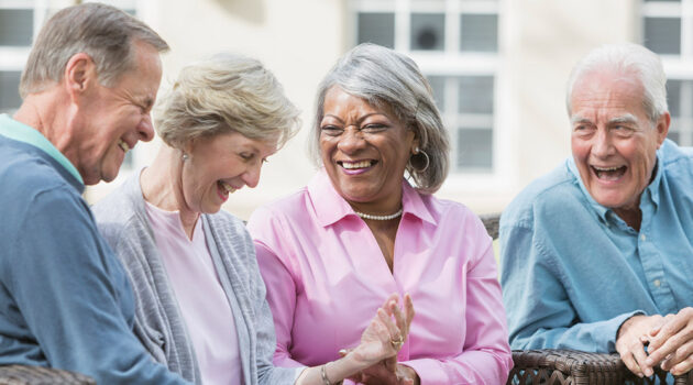 Older people sitting and laughing.