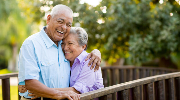 Older couple hugging.