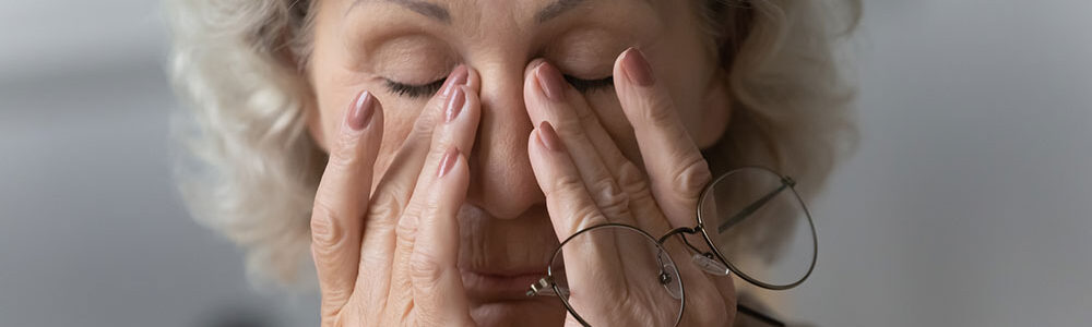 Woman rubbing eyes.