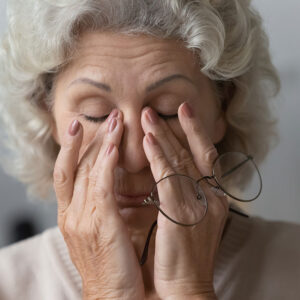 Woman rubbing eyes.