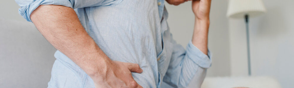 Man holding stomach in pain.