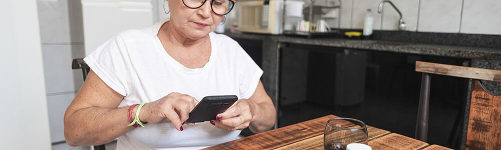 lady sitting at table sorting pills.