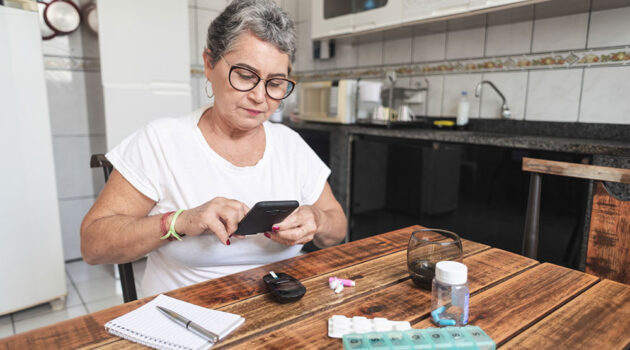 lady sitting at table sorting pills.