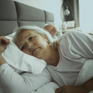 Woman lying in bed awake.