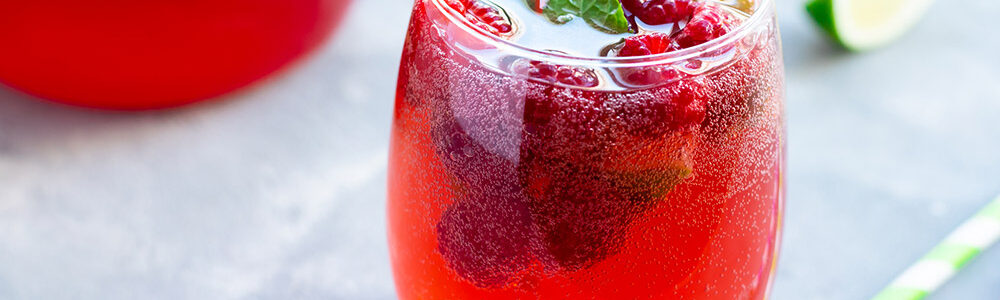 Red mixed drink on a table.