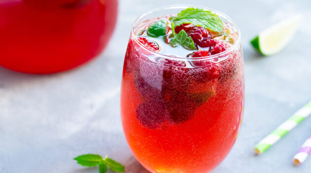 Red mixed drink on a table.