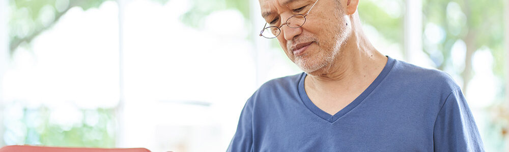 Man sitting in front of food at a table.