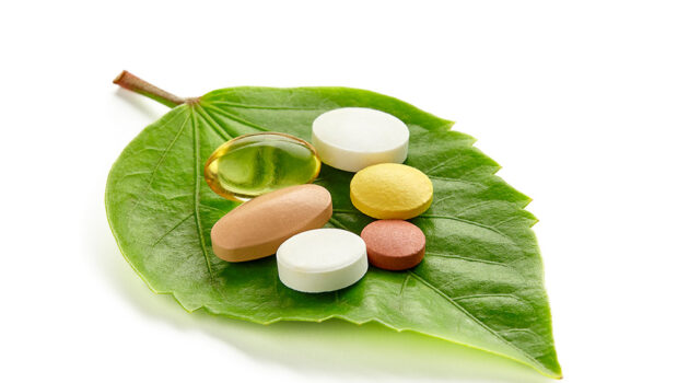 Supplements on a leaf to illustrate that there are natural alternatives to drugs.